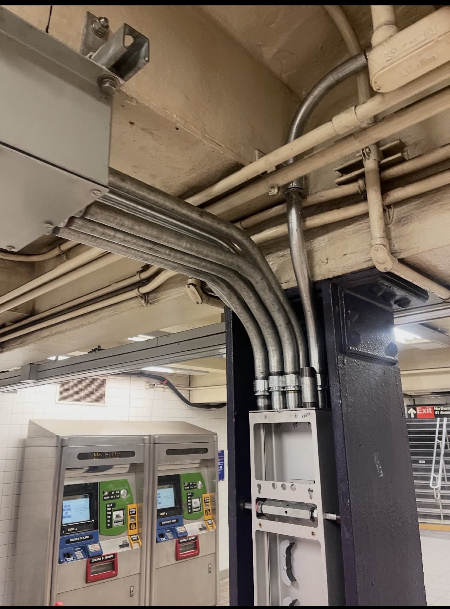 EMT conduit bends into a column at a transit station