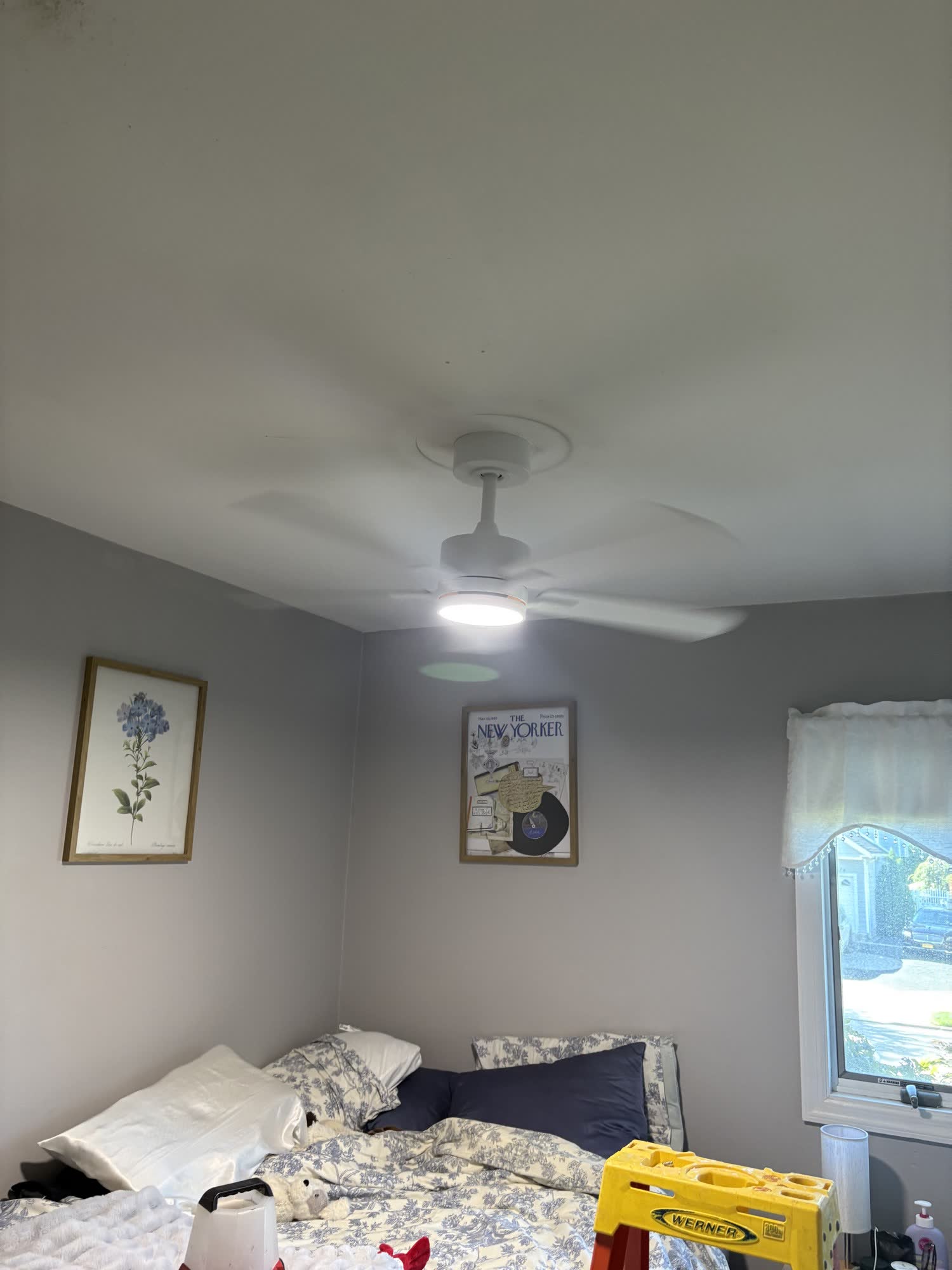 White ceiling fan with light installed in a bedroom