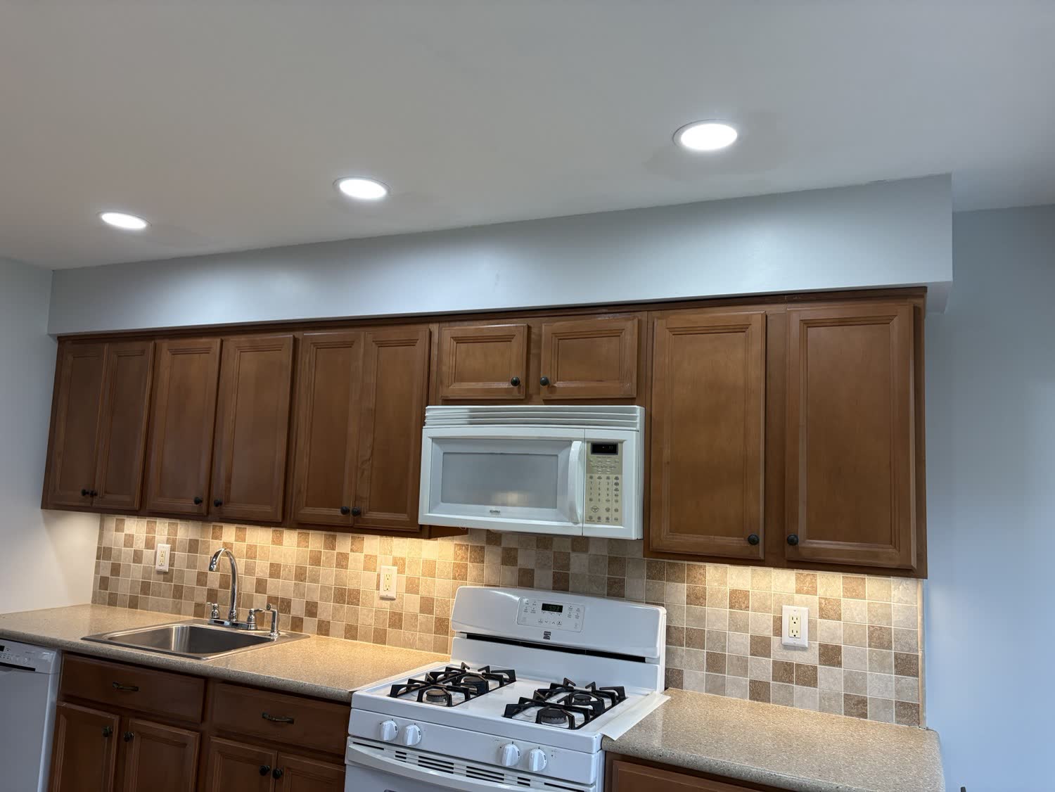 Kitchen with new recessed ceiling lights and under cabinet lighting