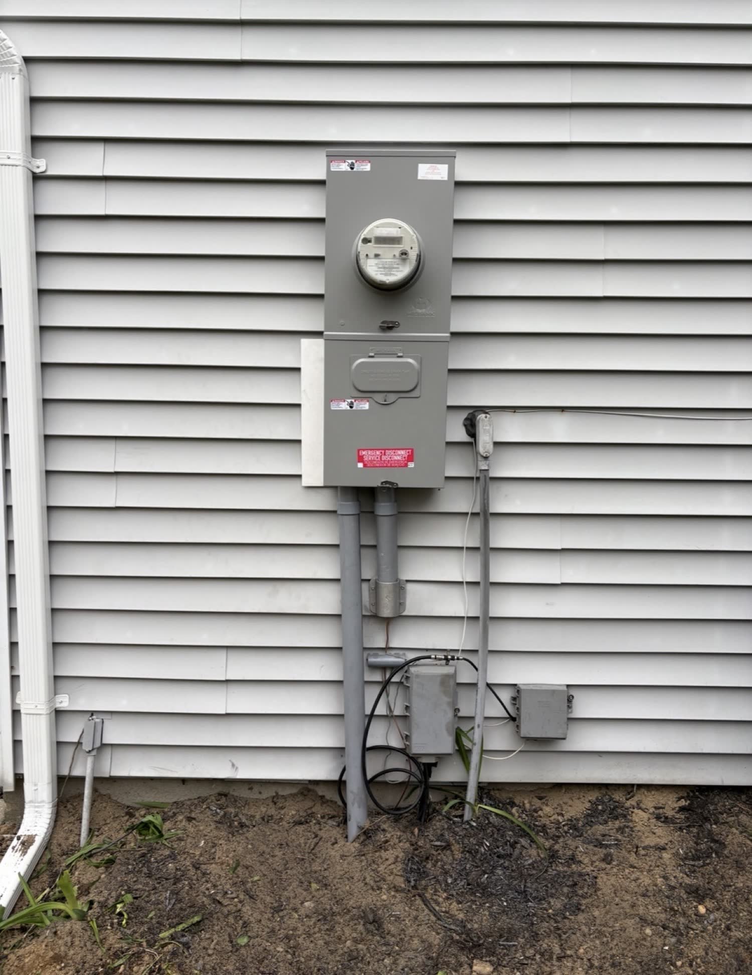 Outdoor meter and emergency disconnect combo on vinyl siding