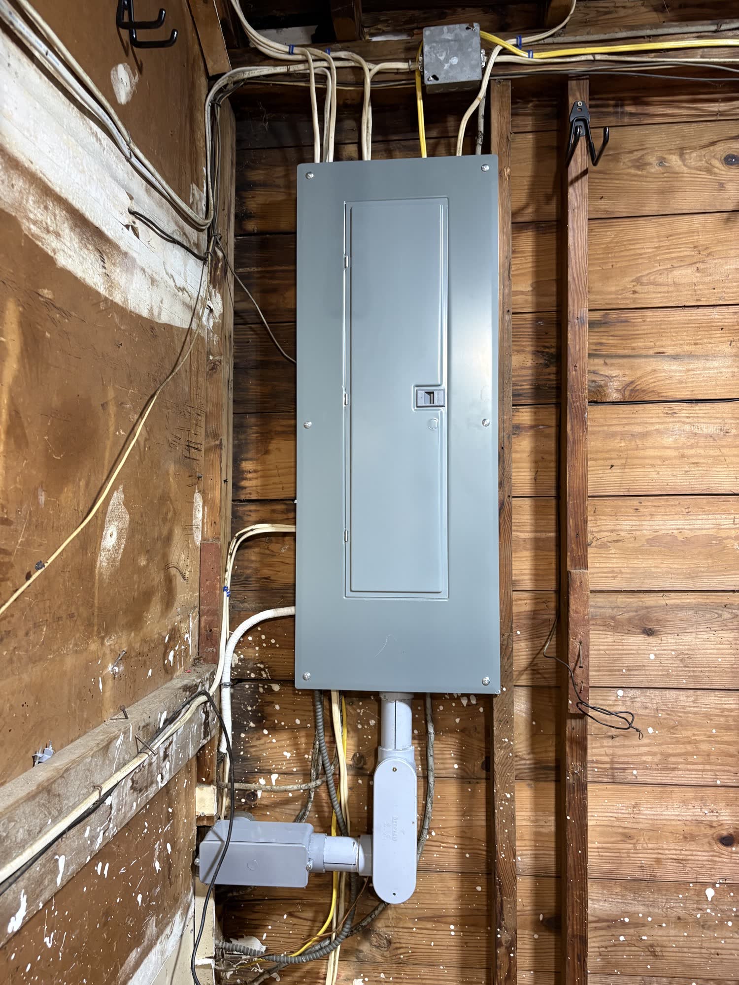 Finished residential panel with cover installed in a wood basement