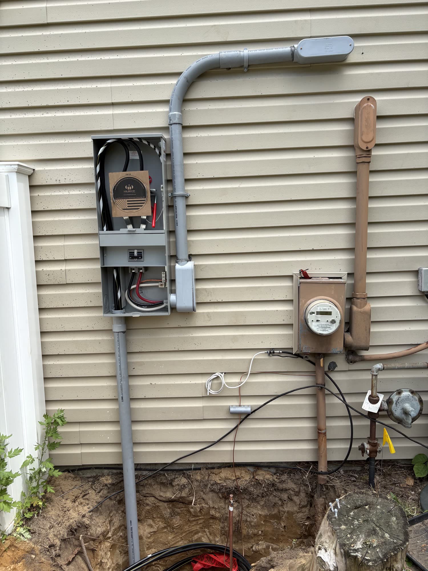 New meter combo being installed next to the existing rusted meter and riser
